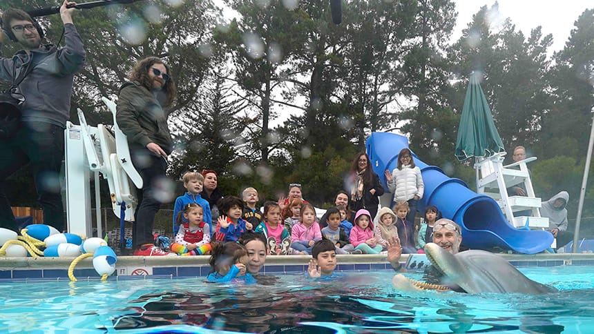 A group of kids and families testing the prototype in a pool.