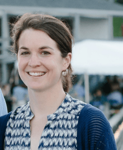 Head shot of smiling brown-haired woman.