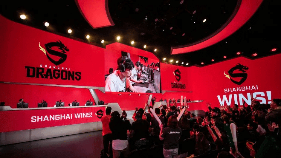 The Shanghai Gladiators compete on stage during the 2019 season while the live crowd cheers.