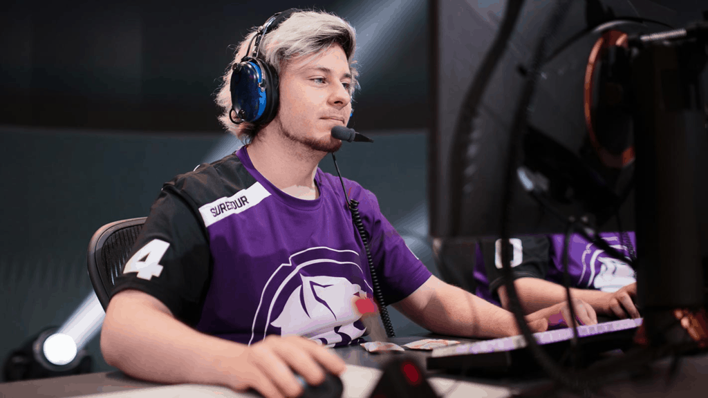 Surefour seated in front of the monitor in the middle of a game of Overwatch