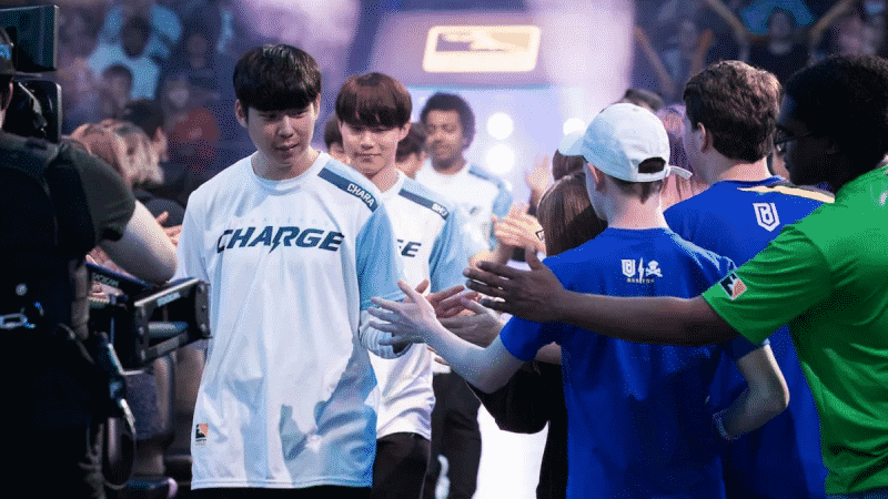 The Guangzhou Charge Overwatch League team high fiving fans in the Overwatch League arena