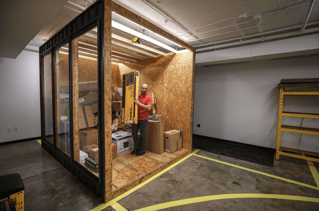 Dextrous Robotics co-founder Evan Drumwright stands inside a mock shipping container in the company's Crosstown Concourse headquarters. The company located to Memphis to connect with the major logistics industry players there.