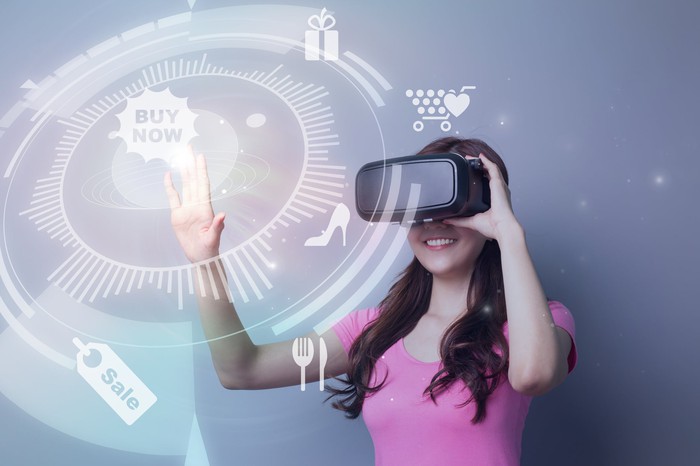 A woman wearing a VR headset and touching a 'Buy Now' icon.