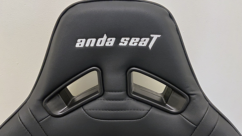 The logo appears on the chair twice, as well as once on the headrest pillow and lumbar pillow